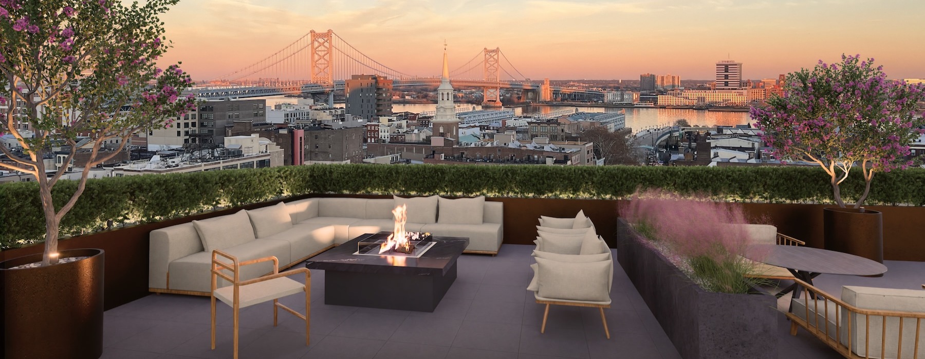 an outdoor lounge with a couch and a fire pit