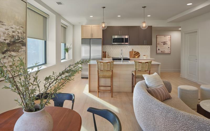 a living room with a couch, tables and chairs
