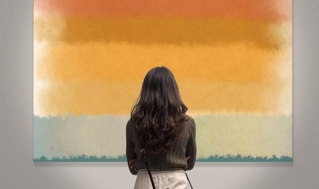 a person looking at a painting